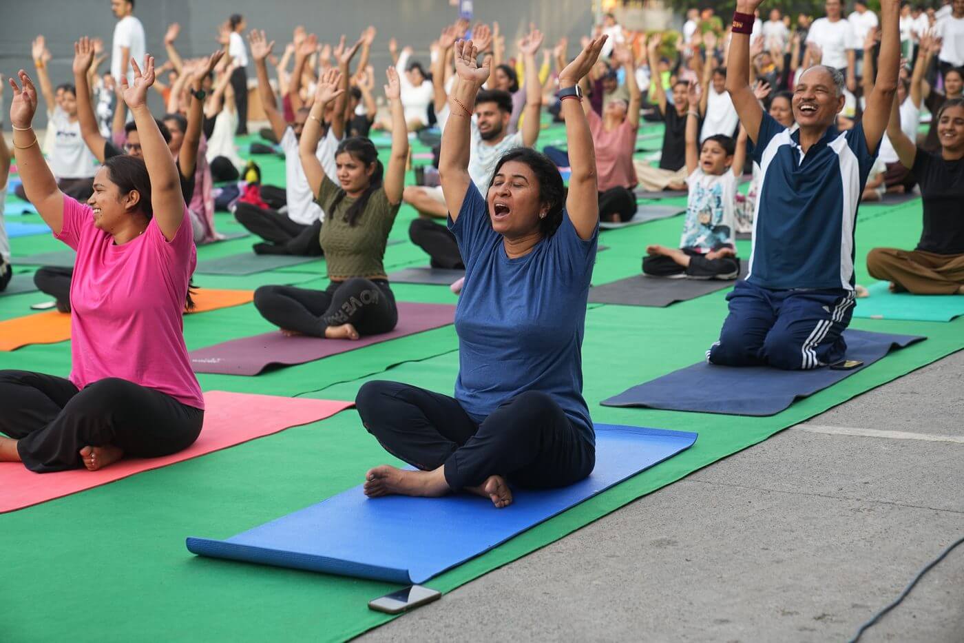 Laughing yoga at IYD 2026 — arms raised, pure joy
